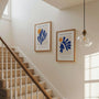 Set of 2 blue cutouts posters arranged in gallery wall with modern abstract decor