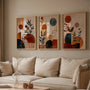abstract boho poster set of 3 with warm neutral colors styled in modern living room
