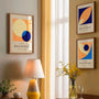 orange cream navy and light blue bauhaus poster set arranged in modern gallery wall